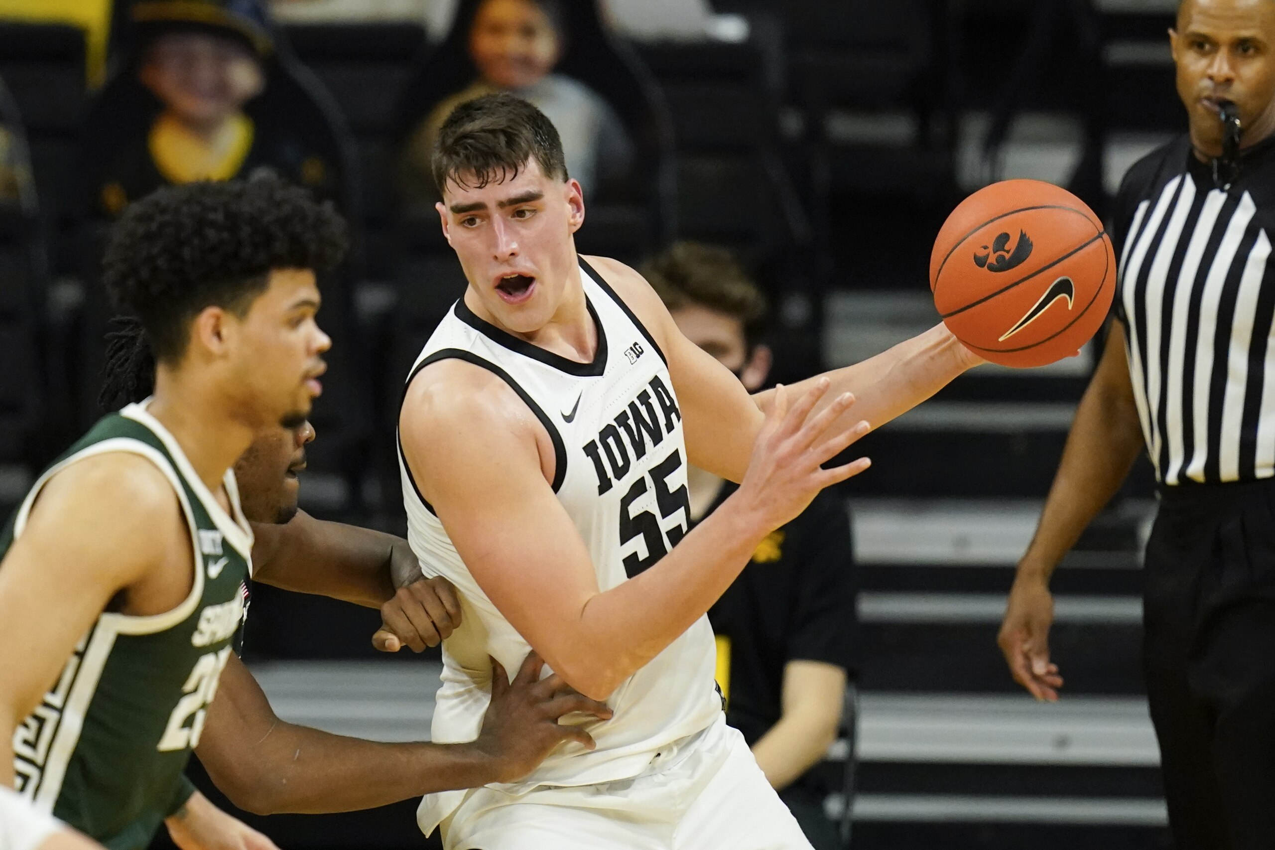 Iowa center Luka Garza (55) drives to the basket during the first half of an NCAA college basketball game against Michigan State, Tuesday, Feb. 2, 2021, in Iowa City, Iowa. (AP Photo/Charlie Neibergall)