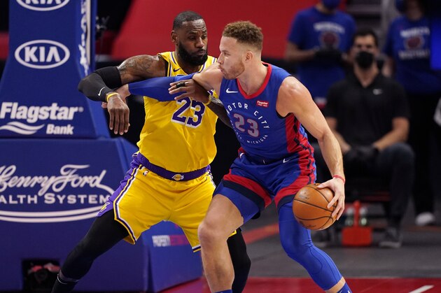 Detroit Pistons forward Blake Griffin (23) is defended by Los Angeles Lakers forward LeBron James (23) during the first half of an NBA basketball game, Thursday, Jan. 28, 2021, in Detroit. (AP Photo/Carlos Osorio)