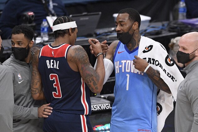 Houston Rockets guard John Wall (1) and Washington Wizards guard Bradley Beal (3) meet up after an NBA basketball game, Monday, Feb. 15, 2021, in Washington. The Wizards won 131-119. (AP Photo/Nick Wass)
