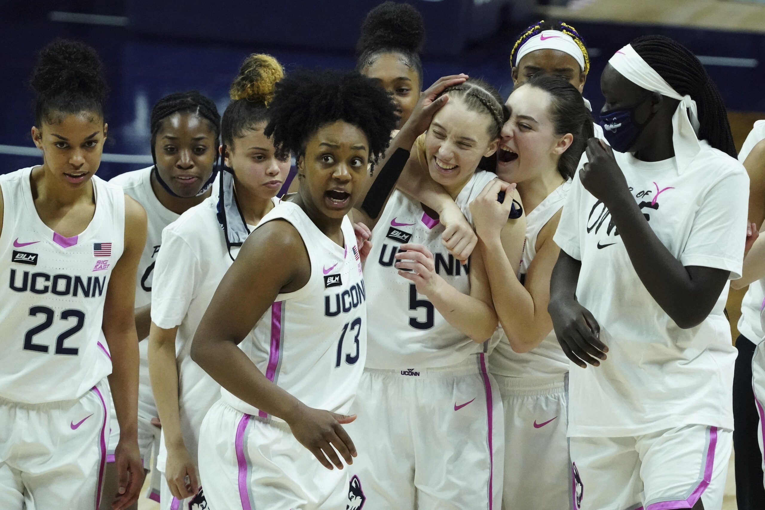 Connecticut guard Nika Muhl (10) hugs guard Paige Bueckers (5) after defeating South Carolina in overtime of an NCAA college basketball game in Storrs, Conn., Monday, Feb. 8, 2021. (David Butler/Pool Photo via AP)