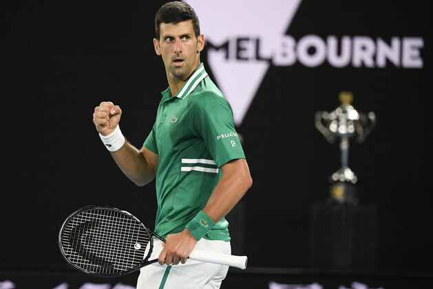 Serbia's Novak Djokovic reacts after winning a point against Germany's Alexander Zverev during their quarterfinal match at the Australian Open tennis championship in Melbourne, Australia, Tuesday, Feb. 16, 2021.(AP Photo/Andy Brownbill)