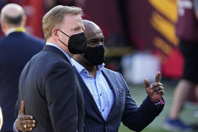 Commissioner Roger Goodell, left, and NFL Players Association executive director DeMaurice Smith talk before the NFL Super Bowl 55 football game between the Kansas City Chiefs and Tampa Bay Buccaneers, Sunday, Feb. 7, 2021, in Tampa, Fla. (AP Photo/David J. Phillip)