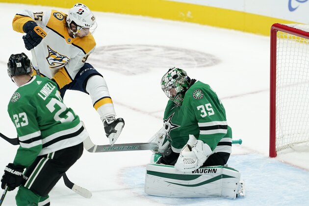 Nashville Predators' Matt Duchene (95) leaps to clear a shot blocked by Dallas Stars goaltender Anton Khudobin (35) as right wing Esa Lindell (23) looks on during an NHL hockey game in Dallas, Friday, Jan. 22, 2021. (AP Photo/Tony Gutierrez)