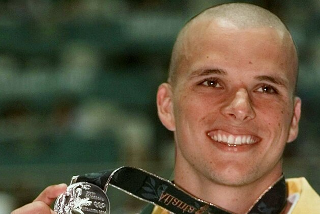 **FILE**Scott Miller of Australia holds up his silver medal that he won in the men's 100 meter butterfly at the 1996 Summer Olympics in Atlanta, in this July 24, 1996 file photo. Miller was charged Thursday, April 17, 2008 with drug offenses along with the son of a former Australian rugby captain. Police said they found a pill press capable of producing up to 27,000 pills an hour, and a professional tablet counter after searching a storage facility in northern Sydney. They arrested Miller, 33, and seized steroids after raiding a home later in the day.  (AP Photo/Denis Paquin,file)