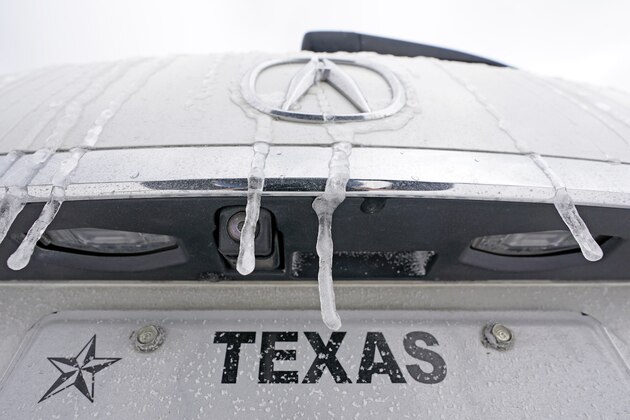 Icicles hang on the back of a vehicle Monday, Feb. 15, 2021, in Houston. A frigid blast of winter weather across the U.S. plunged Texas into an unusually icy emergency Monday that knocked out power to more than 2 million people and shut down grocery stores and dangerously snowy roads. (AP Photo/David J. Phillip)
