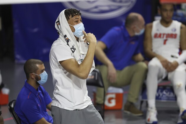 Florida's Keyontae Johnson is shown on the sidelines during the second half of an NCAA college basketball game Tuesday, Jan. 19. 2021, in Gainesville, Fla. Florida standout Keyontae Johnson has one of the best seats in the O’Connell Center. He’s just a few feet from the court, close enough to hear calls, see screens coming and know where the ball needs to go next. (AP Photo/Matt Stamey)