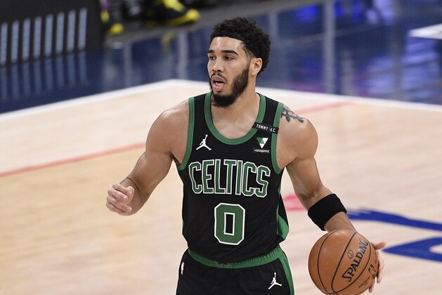 Boston Celtics forward Jayson Tatum (0) dribbles the ball during the first half of an NBA basketball game against the Washington Wizards, Sunday, Feb. 14, 2021, in Washington. (AP Photo/Nick Wass)