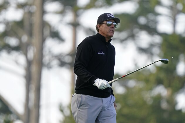 Phil Mickelson follows his approach shot from the 10th fairway of the Spyglass Hill Golf Course during the first round of the AT&T Pebble Beach Pro-Am golf tournament Thursday, Feb. 11, 2021, in Pebble Beach, Calif. (AP Photo/Eric Risberg)