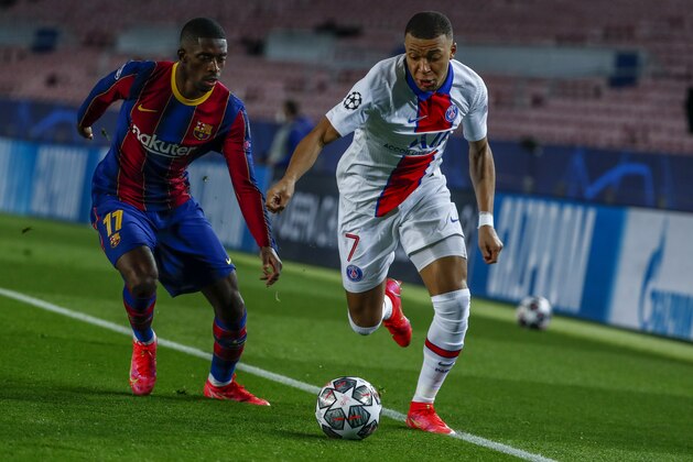 Barcelona's Ousmane Dembele, left, vies for the ball with PSG's Kylian Mbappe during the Champions League round of 16, first leg soccer match between FC Barcelona and Paris Saint-Germain at the Camp Nou stadium in Barcelona, Spain, Tuesday, Feb. 16, 2021. (AP Photo/Joan Monfort)