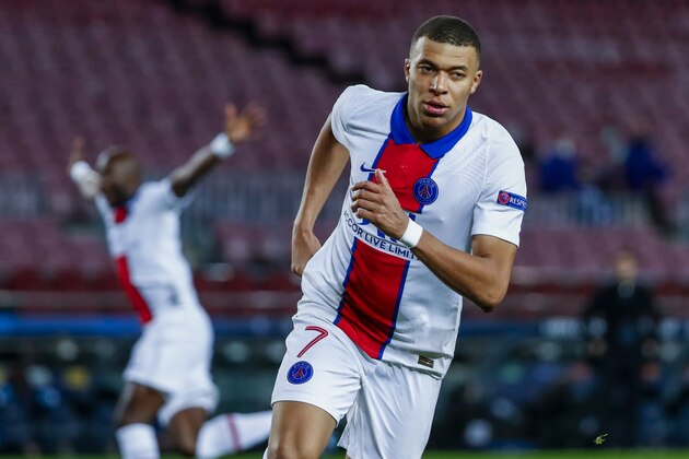 PSG's Kylian Mbappe celebrates after scoring during the Champions League round of 16, first leg soccer match between FC Barcelona and Paris Saint-Germain at the Camp Nou stadium in Barcelona, Spain, Tuesday, Feb. 16, 2021. (AP Photo/Joan Monfort)
