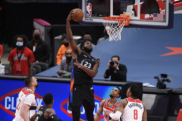 New York Knicks center Mitchell Robinson (23) goes to the basket between Washington Wizards guard Ish Smith (14), forward Rui Hachimura (8) and center Alex Len, left, during the first half of an NBA basketball game, Friday, Feb. 12, 2021, in Washington. (AP Photo/Nick Wass)