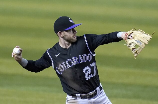 Colorado Rockies shortstop Trevor Story throws to first base against the Arizona Diamondbacks in the first inning during the second game of a baseball doubleheader Friday, Sept. 25, 2020, in Phoenix. (AP Photo/Ross D. Franklin)