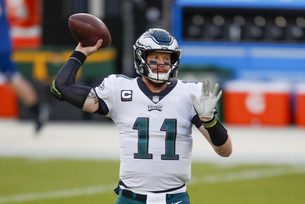 Philadelphia Eagles' Carson Wentz warms up before an NFL football game against the Green Bay Packers Sunday, Dec. 6, 2020, in Green Bay, Wis. (AP Photo/Matt Ludtke)