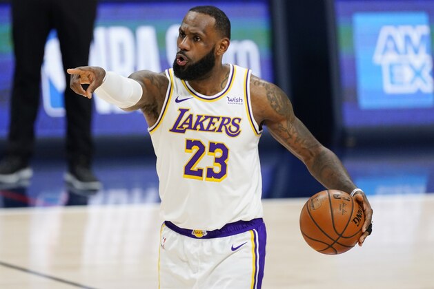 Los Angeles Lakers forward LeBron James gestures to teammates during the second half of an NBA basketball game against the Denver Nuggets on Sunday, Feb. 14, 2021, in Denver. (AP Photo/David Zalubowski)