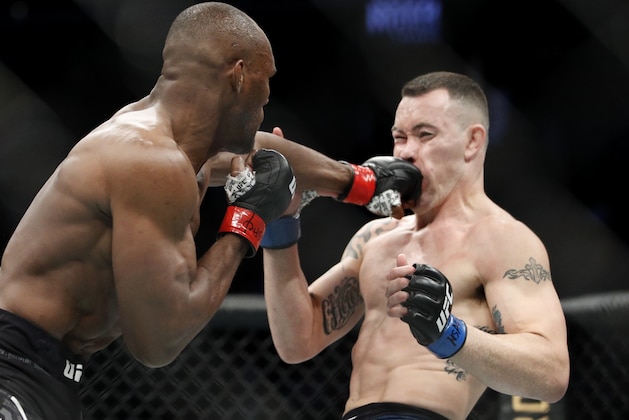 Kamaru Usman hits Colby Covington in a mixed martial arts welterweight championship bout at UFC 245, Saturday, Dec. 14, 2019, in Las Vegas. (AP Photo/John Locher)