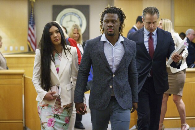 Philadelphia Phillies baseball player Odubel Herrera leaves a courtroom with his girlfriend, Melany Martinez-Angulo, after a hearing on a domestic violence case in Atlantic City, N.J., Wednesday, July 3, 2019. Domestic assault charges against Herrera were dismissed Wednesday after his girlfriend declined to press charges. (Jessica Griffin/The Philadelphia Inquirer via AP, Pool)
