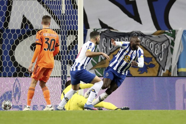 Porto's Moussa Marega, right, celebrates after scoring his side's second goal during the Champions League round of 16, first leg, soccer match between FC Porto and Juventus at the Dragao stadium in Porto, Portugal, Wednesday, Feb. 17, 2021. (AP Photo/Luis Vieira)