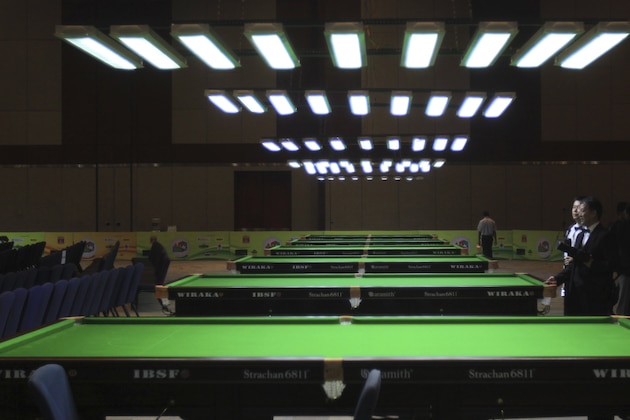 Participants look at tables during the opening ceremony of Oil and Natural Gas Corporation Limited-International Billiards and Snooker Federation World Snooker Championship 2009, in Hyderabad, India, Saturday, Nov. 14, 2009. Players from 60 countries will participate in the Championship which will be held from Nov. 15-25. (AP Photo/Mahesh Kumar A)
