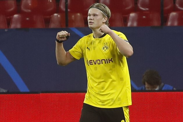 Dortmund's Erling Haaland celebrates after scoring his side's third goal during the Champions League, round of 16, first leg soccer match between Sevilla and Borussia Dortmund at the Ramon Sanchez Pizjuan stadium in Seville, Spain, Wednesday, Feb. 17, 2021. (AP Photo/Angel Fernandez)