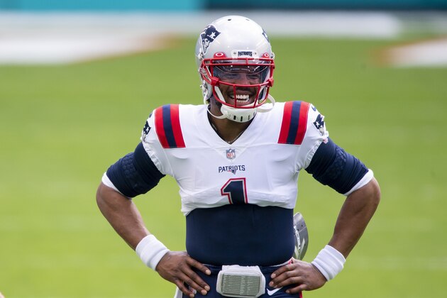 New England Patriots quarterback Cam Newton (1) smiles on the field before the Patriots take on the Miami Dolphins during an NFL football game, Sunday, Dec. 20, 2020, in Miami Gardens, Fla. (AP Photo/Doug Murray)