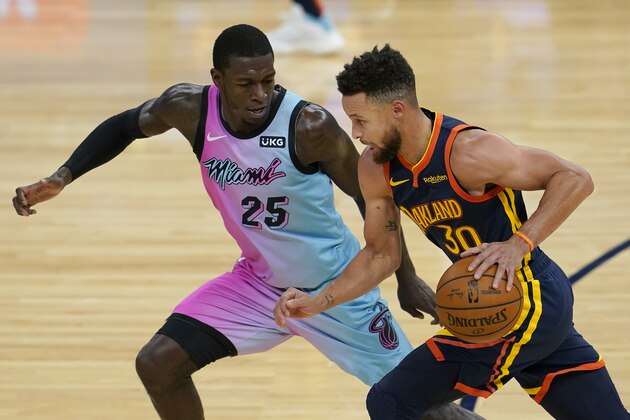 Golden State Warriors guard Stephen Curry (30) is defended by Miami Heat guard Kendrick Nunn (25) during the first half of an NBA basketball game in San Francisco, Wednesday, Feb. 17, 2021. (AP Photo/Jeff Chiu)