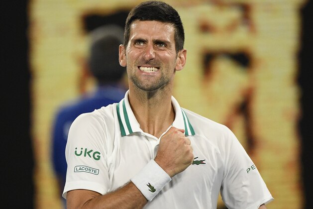 Serbia's Novak Djokovic celebrates after defeating Russia's Aslan Karatsev in their semifinal match at the Australian Open tennis championship in Melbourne, Australia, Thursday, Feb. 18, 2021.(AP Photo/Andy Brownbill)