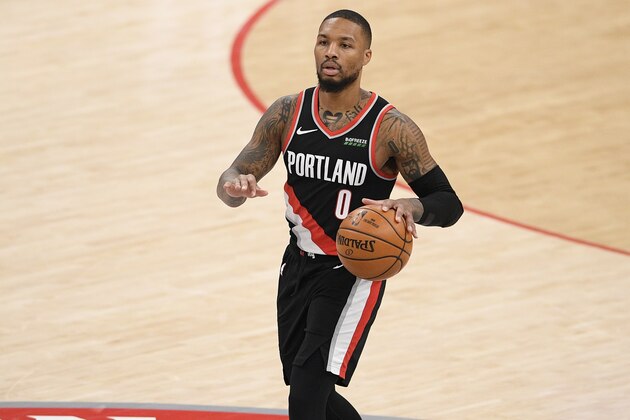 Portland Trail Blazers guard Damian Lillard (0) dribbles the ball during the second half of an NBA basketball game against the Washington Wizards, Tuesday, Feb. 2, 2021, in Washington. (AP Photo/Nick Wass)
