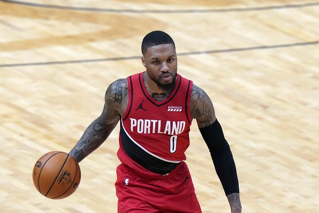 Portland Trail Blazers guard Damian Lillard (0) moves the ball up court in the first half of an NBA basketball game against the New Orleans Pelicans in New Orleans, Wednesday, Feb. 17, 2021. (AP Photo/Gerald Herbert)