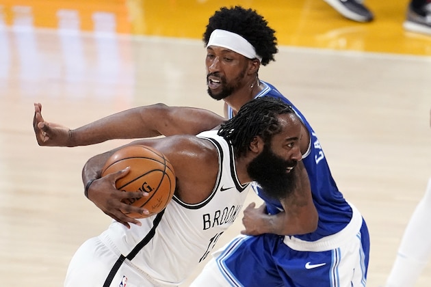 Brooklyn Nets guard James Harden, left, dribbles around Los Angeles Lakers guard Kentavious Caldwell-Pope during the first half of an NBA basketball game Thursday, Feb. 18, 2021, in Los Angeles. (AP Photo/Marcio Jose Sanchez)