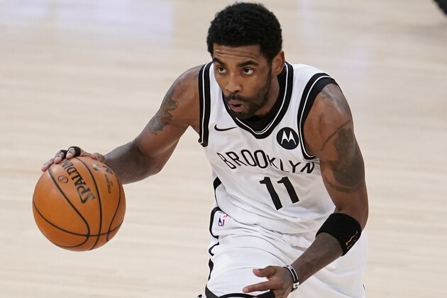 Brooklyn Nets guard Kyrie Irving dribbles against the Los Angeles Lakers during the first half of an NBA basketball game Thursday, Feb. 18, 2021, in Los Angeles. (AP Photo/Marcio Jose Sanchez)