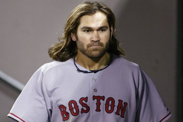Boston Red Sox's Johnny Damon purses his lips in the visitors' dugout after failing to get a hit in the ninth inning, ending his 18-game hitting streak Saturday, May 14, 2005, in Seattle. The Red Sox beat the Seattle Mariners 6-3. (AP Photo/Ted S. Warren)