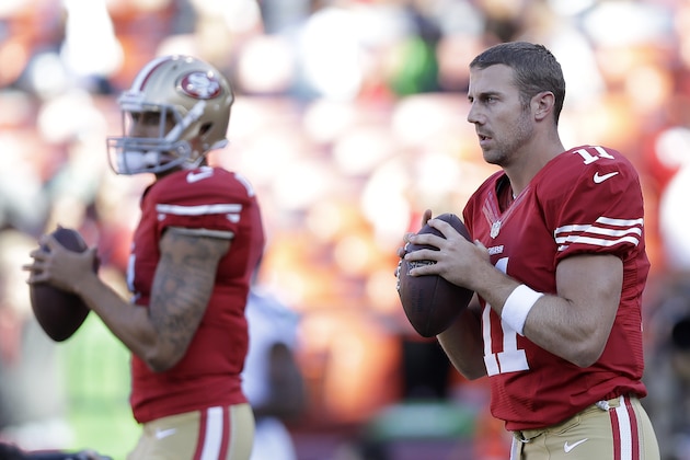 San Francisco 49ers quarterbacks Colin Kaepernick, left, and Alex Smith warm up before an NFL football game against the Seattle Seahawks in San Francisco, Thursday, Oct. 18, 2012. (AP Photo/Marcio Jose Sanchez)