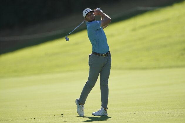 Sam Burns hits his second shot on the 18th hole during the first round of the Genesis Invitational golf tournament at Riviera Country Club, Thursday, Feb. 18, 2021, in the Pacific Palisades area of Los Angeles. (AP Photo/Ryan Kang)