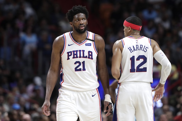 Philadelphia 76ers center Joel Embiid (21) talks with forward Tobias Harris (12) during the second half of an NBA basketball game against the Miami Heat, Monday, Feb. 3, 2020, in Miami. The Heat won 137-106. (AP Photo/Lynne Sladky)