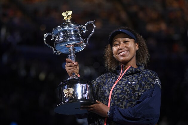 Japan's Naomi Osaka holds the Daphne Akhurst Memorial Cup aloft after defeating United States Jennifer Brady in the women's singles final at the Australian Open tennis championship in Melbourne, Australia, Saturday, Feb. 20, 2021.(AP Photo/Andy Brownbill)