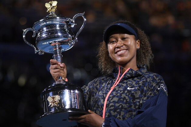 Japan's Naomi Osaka holds the Daphne Akhurst Memorial Cup aloft after defeating United States Jennifer Brady in the women's singles final at the Australian Open tennis championship in Melbourne, Australia, Saturday, Feb. 20, 2021.(AP Photo/Andy Brownbill)