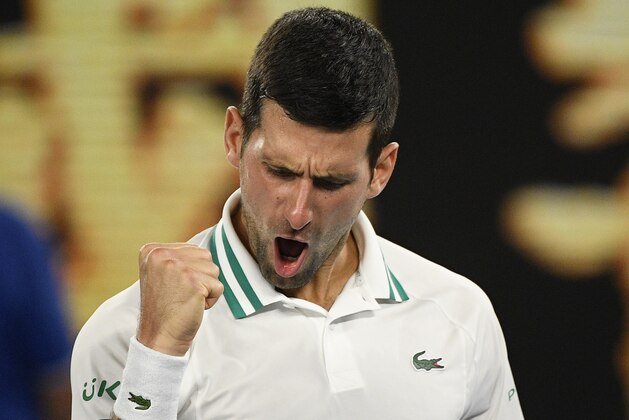 Serbia's Novak Djokovic celebrates after defeating Russia's Aslan Karatsev in their semifinal match at the Australian Open tennis championship in Melbourne, Australia, Thursday, Feb. 18, 2021..(AP Photo/Andy Brownbill)