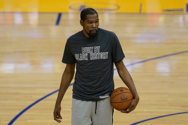 Brooklyn Nets forward Kevin Durant wears a Black History Month shirt as he warms up before an NBA basketball game against the Golden State Warriors in San Francisco, Saturday, Feb. 13, 2021. (AP Photo/Jeff Chiu)