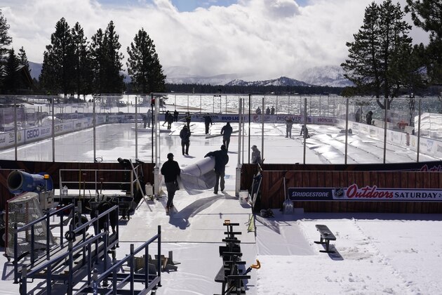Workers put the finishing touches on the temporary ice rink, Friday, Feb. 19, 2021, built at the Edgewood Tahoe Resort, that will host two NHL games, this weekend at Stateline, Nev. The Colorado Avalanche will play the Vegas Golden Knights Saturday and the Philadelphia Flyers will face off against the Boston Bruins Sunday. (AP Photo/Rich Pedroncelli)