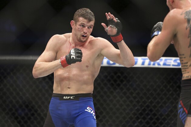 Chas Skelly fights Jason Knight in a mixed martial arts bout at UFC 211 on Saturday, May 13, 2017, in Dallas. Knight won via 3rd round stoppage. (AP Photo/Gregory Payan)