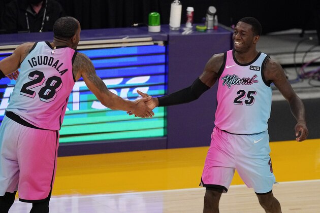 Miami Heat guard Kendrick Nunn, right, is congratulated by forward Andre Iguodala after scoring during the first half of the team's NBA basketball game against the Los Angeles Lakers on Saturday, Feb. 20, 2021, in Los Angeles. (AP Photo/Mark J. Terrill)