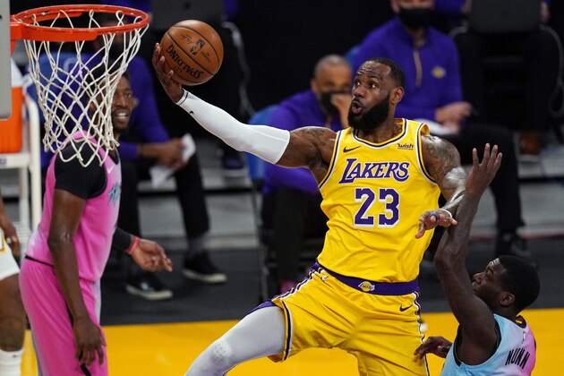 Los Angeles Lakers forward LeBron James shoots as Miami Heat guard Kendrick Nunn, right, defends during the first half of an NBA basketball game Saturday, Feb. 20, 2021, in Los Angeles. (AP Photo/Mark J. Terrill)