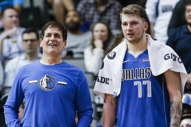 Dallas Mavericks owner Mark Cuban, left, and forward Luka Doncic (77) look on from the sidelines during the second half of an NBA basketball game against the Washington Wizards, Tuesday, Nov. 6, 2018, in Dallas. Dallas won 119-100. (AP Photo/Brandon Wade)