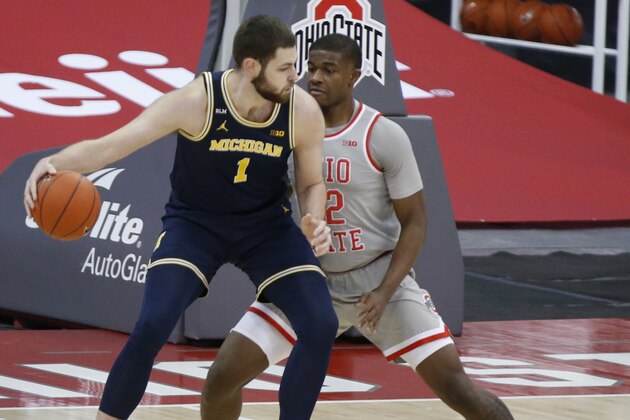 Michigan's Hunter Dickinson, left, posts up against Ohio State's E.J. Liddell during the first half of an NCAA college basketball game Sunday, Feb. 21, 2021, in Columbus, Ohio. (AP Photo/Jay LaPrete)