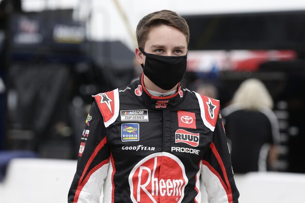 Driver Christopher Bell walks along pit road prior to a NASCAR Cup Series auto race at Charlotte Motor Speedway Sunday, May 24, 2020, in Concord, N.C. (AP Photo/Gerry Broome)