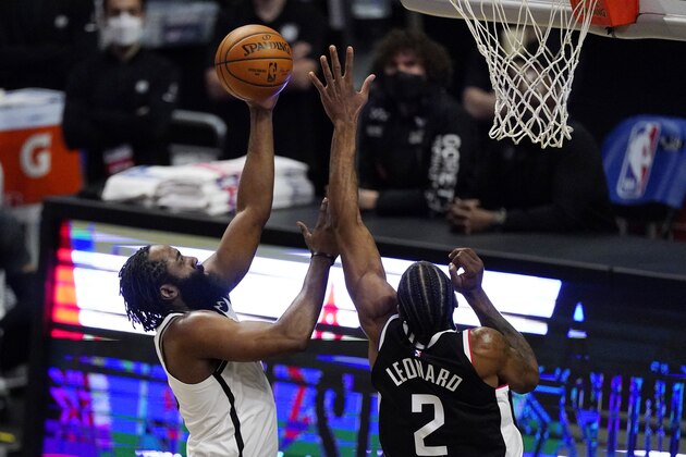 Brooklyn Nets guard James Harden, left, shoots as Los Angeles Clippers forward Kawhi Leonard defends during the first half of an NBA basketball game Sunday, Feb. 21, 2021, in Los Angeles. (AP Photo/Mark J. Terrill)