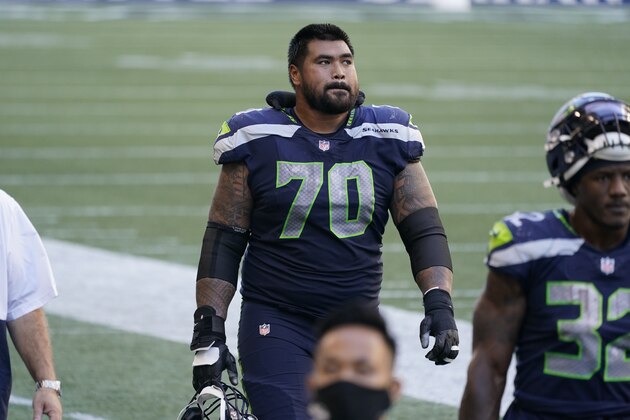 Seattle Seahawks offensive guard Mike Iupati walks off the field at halftime against the Dallas Cowboys in an NFL football game, Sunday, Sept. 27, 2020, in Seattle. (AP Photo/Elaine Thompson)