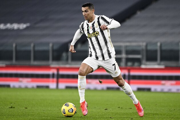 Juventus' Cristiano Ronaldo runs with the ball during the Serie A soccer match between Juventus and Crotone, at the Allianz Stadium in Turin, Italy, Monday, Feb. 22, 2021. (Marco Alpozzi/LaPresse via AP)