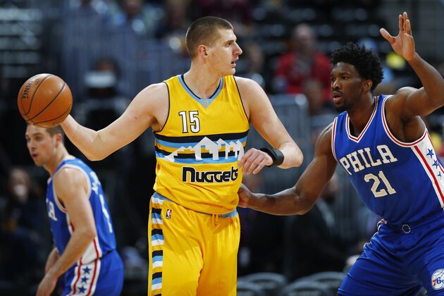 Denver Nuggets forward Nikola Jokic (15), of Serbia, looks to pass the ball as Philadelphia 76ers center Joel Embiid, right, defends in the first half of an NBA basketball game Friday, Dec. 30, 2016, in Denver. (AP Photo/David Zalubowski)