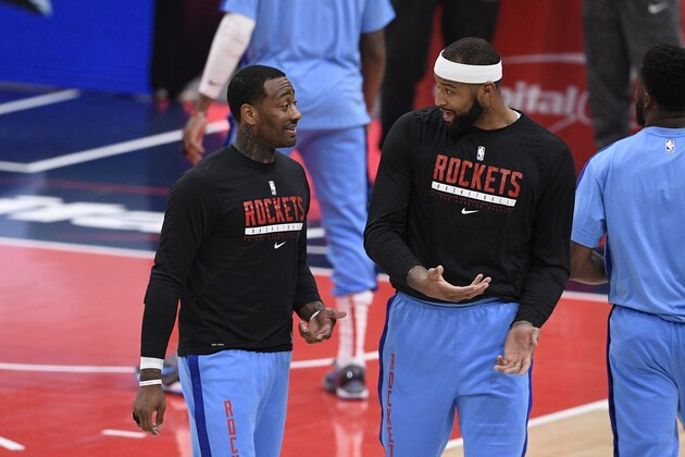 Houston Rockets guard John Wall, left, talks with center DeMarcus Cousins, right, before an NBA basketball game against the Washington Wizards, Monday, Feb. 15, 2021, in Washington. (AP Photo/Nick Wass)